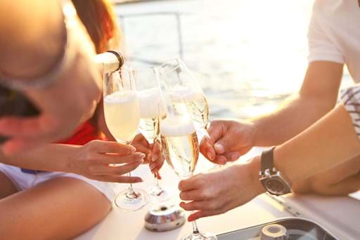 People drinking prosecco on a boat in Venice
