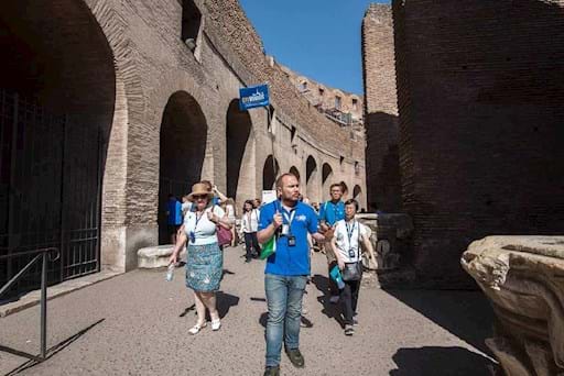 tour guide with tourists inside the colosseum