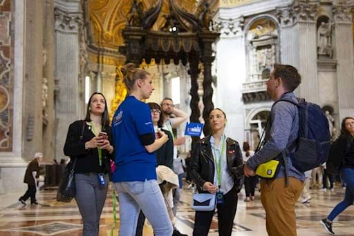 Tourists with their guide inside St Peter Basilica