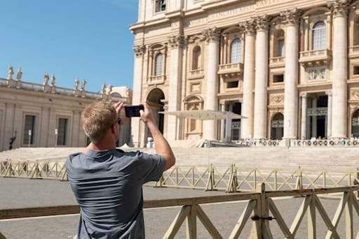 Guy taking a picture of St. Peter Basilica